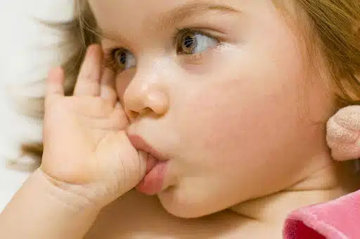 Young child sucking thumb illustrating habits that affect pediatric jaw development