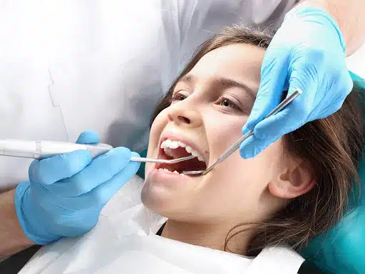 Child receiving a dental exam as part of early orthodontic care for children