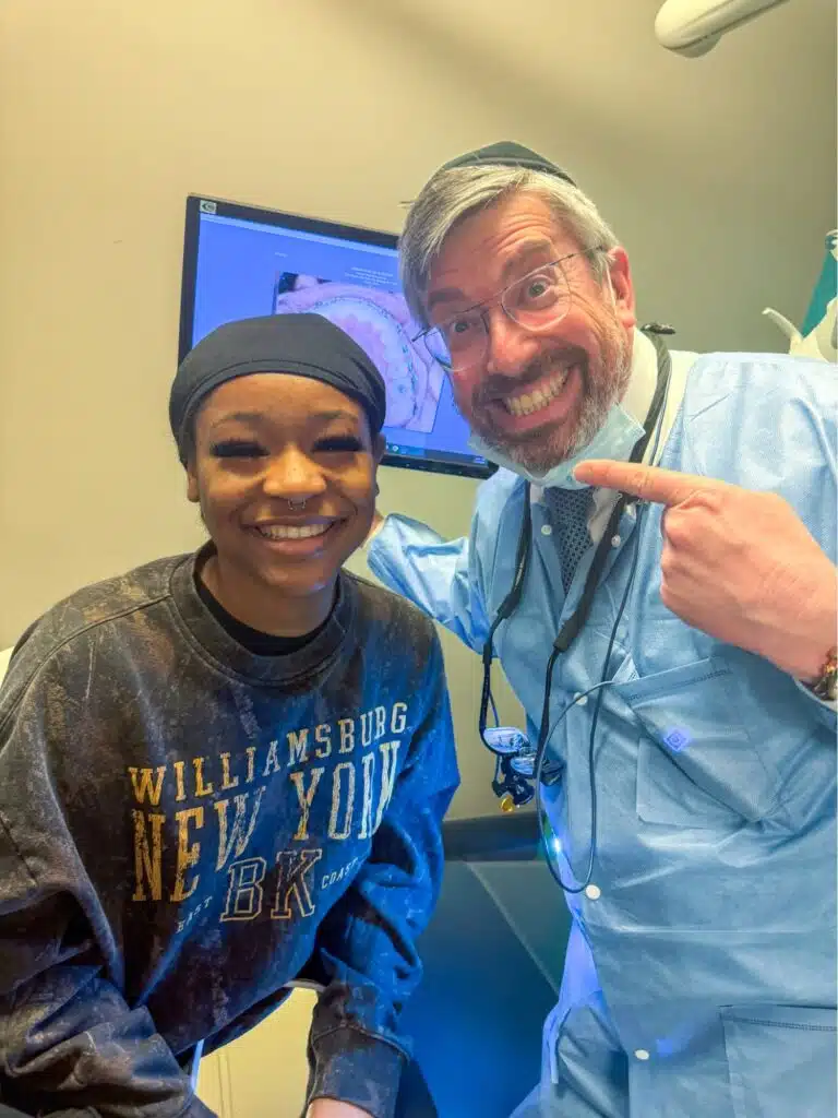 Dr. Yakov Eisenberger smiling with a patient during a follow-up appointment