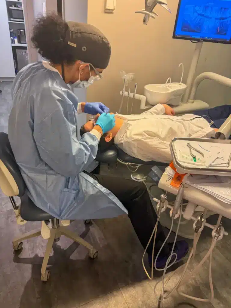 Orthodontist working on a patient in the dental chair