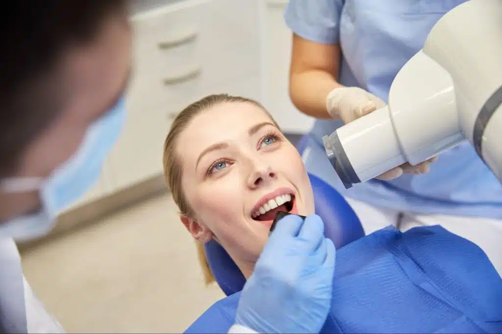 Female patient receiving a digital dental X-ray examination
